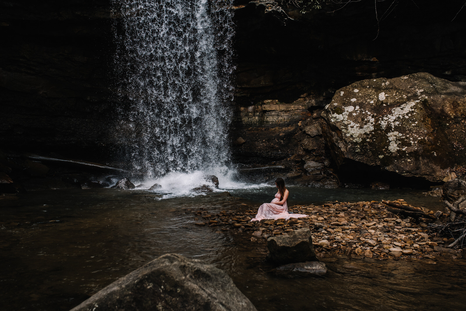  pregnant mom kneels down in the water at ohiopyle cucumber falls for maternity session 