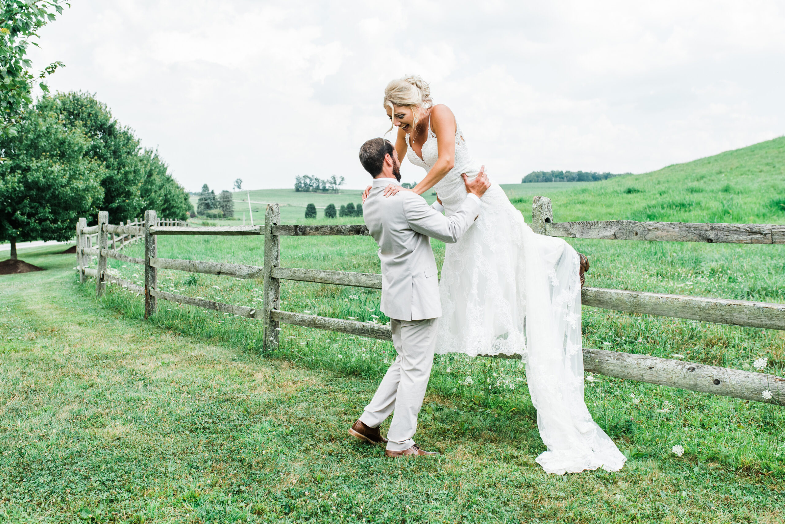 bride jumps from fence Armstrong Farms Wedding Venue