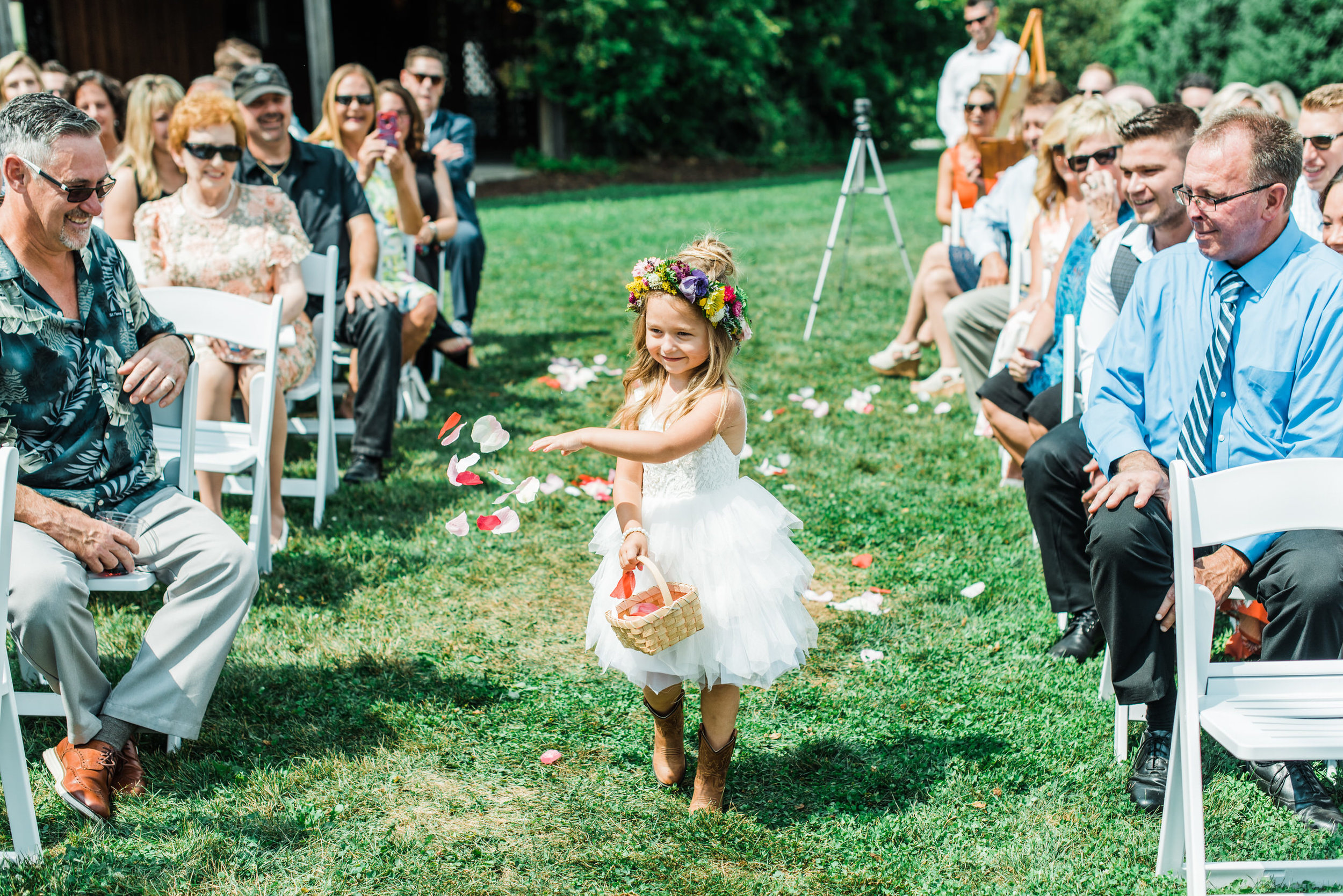 flower girl comes down aisle at Armstrong Farms Wedding Venue