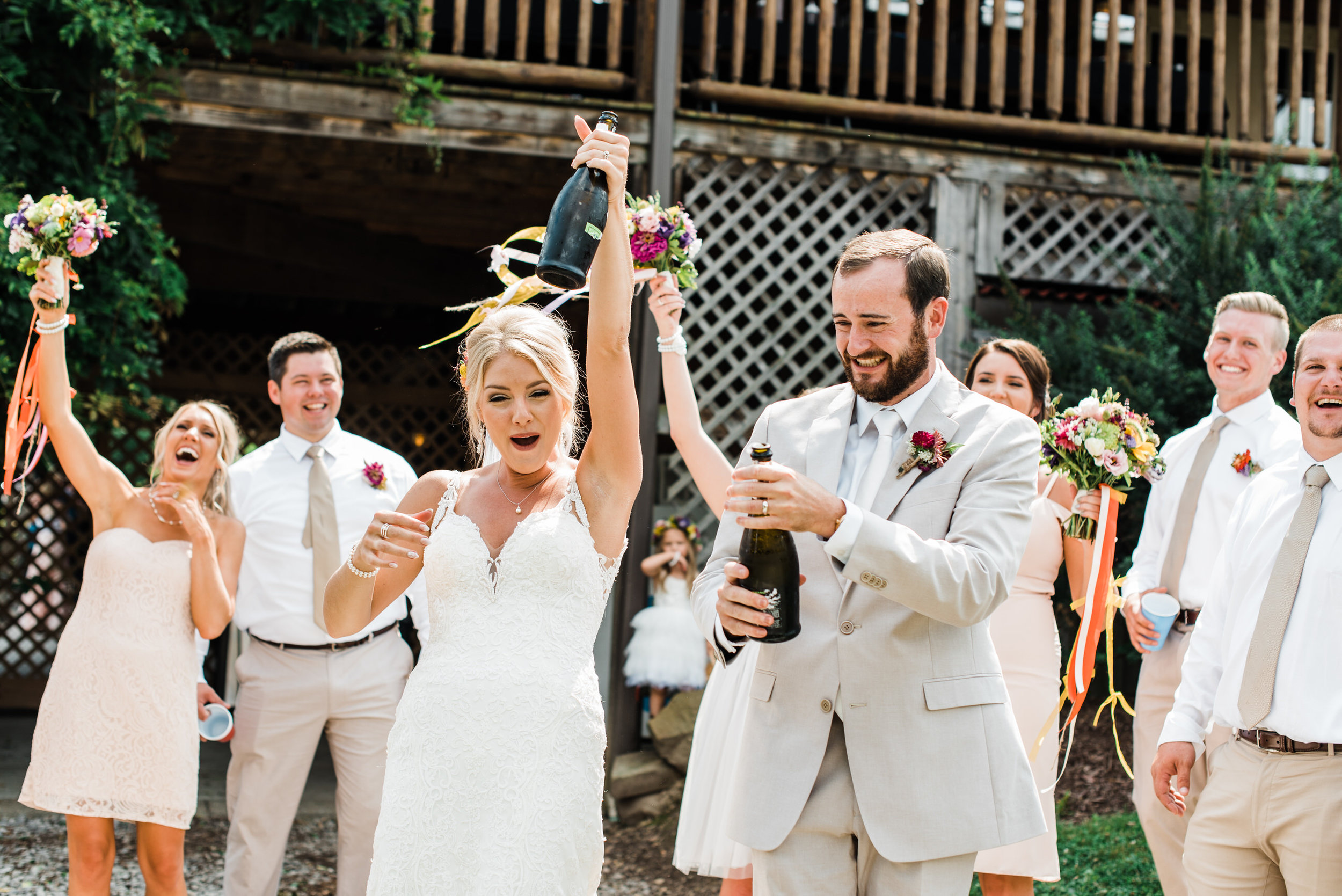 popping champagne at Armstrong Farms Wedding Venue