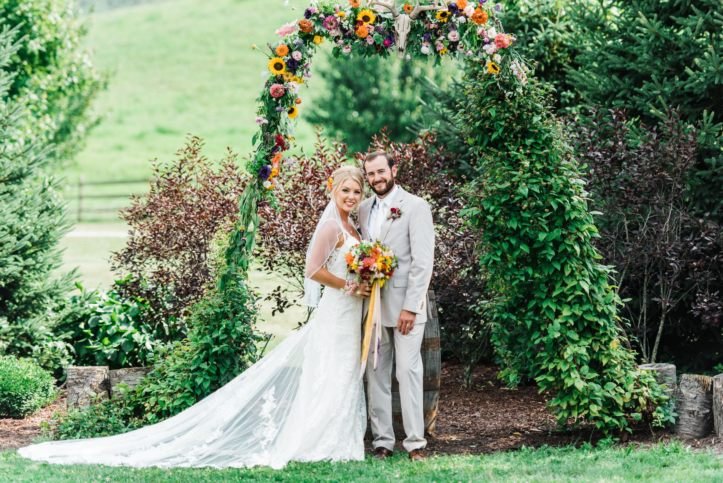 bride and groom at Armstrong Farms Wedding Venue arch